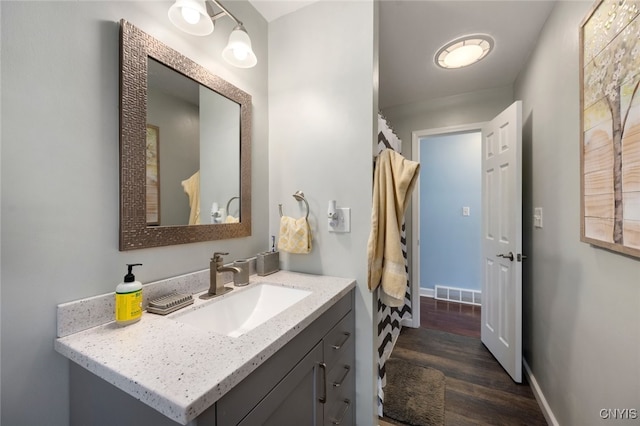 bathroom with hardwood / wood-style floors and vanity