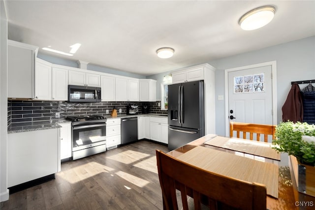 kitchen featuring light stone countertops, light wood-type flooring, tasteful backsplash, stainless steel appliances, and white cabinetry