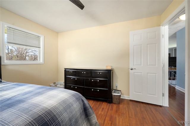 bedroom with ceiling fan and dark wood-type flooring