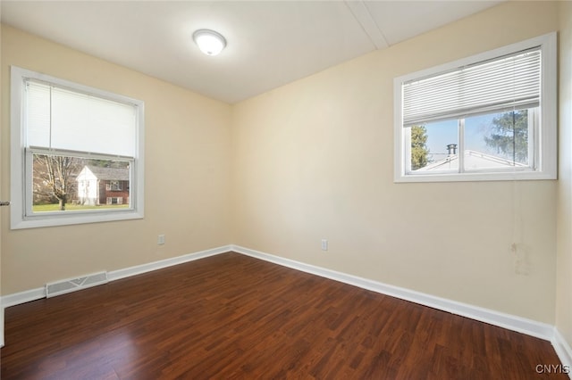 empty room with dark hardwood / wood-style floors