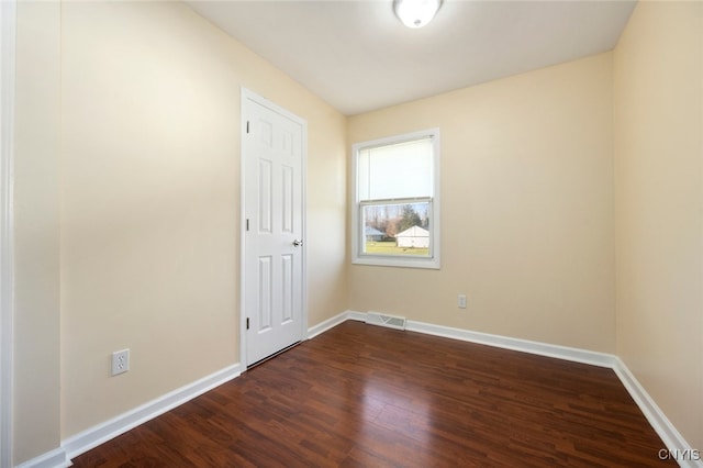 spare room featuring dark hardwood / wood-style flooring