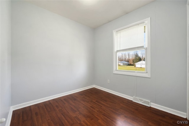 empty room with hardwood / wood-style flooring