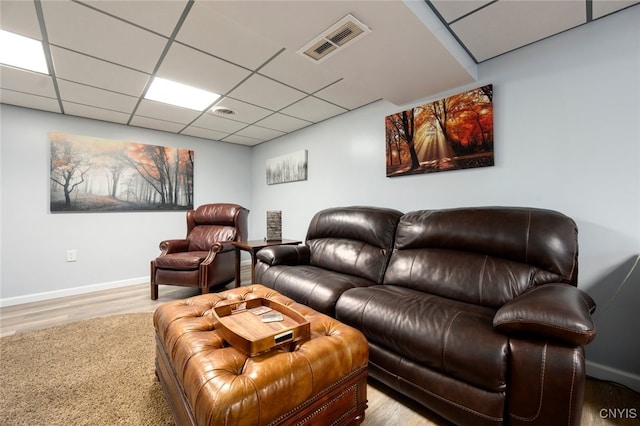 living room with hardwood / wood-style flooring and a drop ceiling