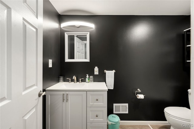 bathroom with tile patterned floors, vanity, and toilet