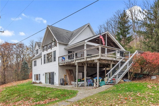 back of house with a lawn and a wooden deck