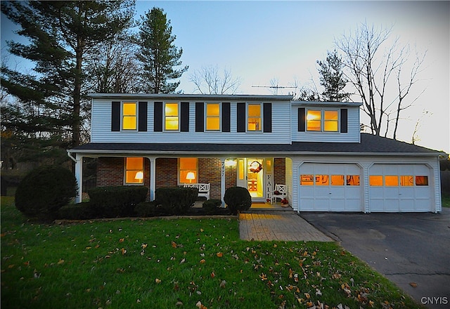 view of front of property with a porch and a yard