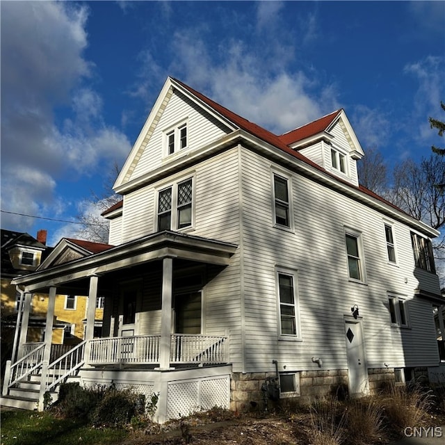 view of side of home with a porch