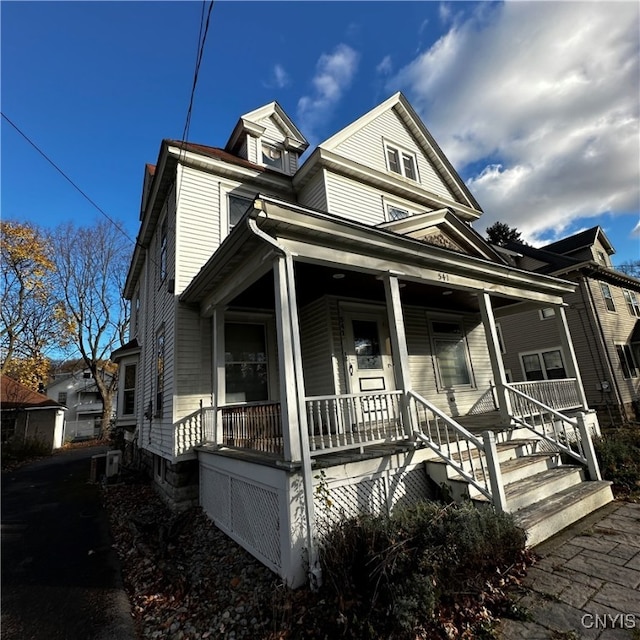 view of front of house with cooling unit and a porch