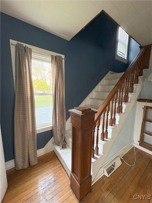 stairs featuring hardwood / wood-style flooring