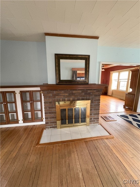 unfurnished living room featuring a fireplace and light wood-type flooring