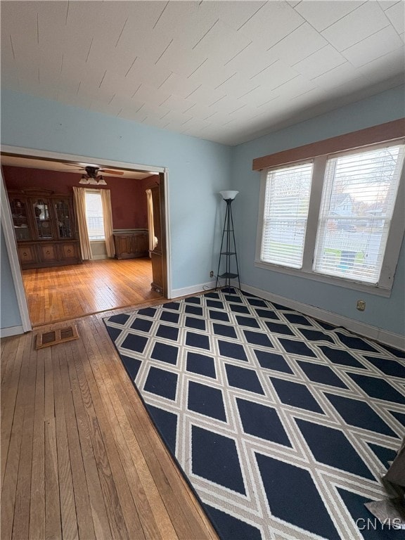 unfurnished room featuring plenty of natural light and hardwood / wood-style floors