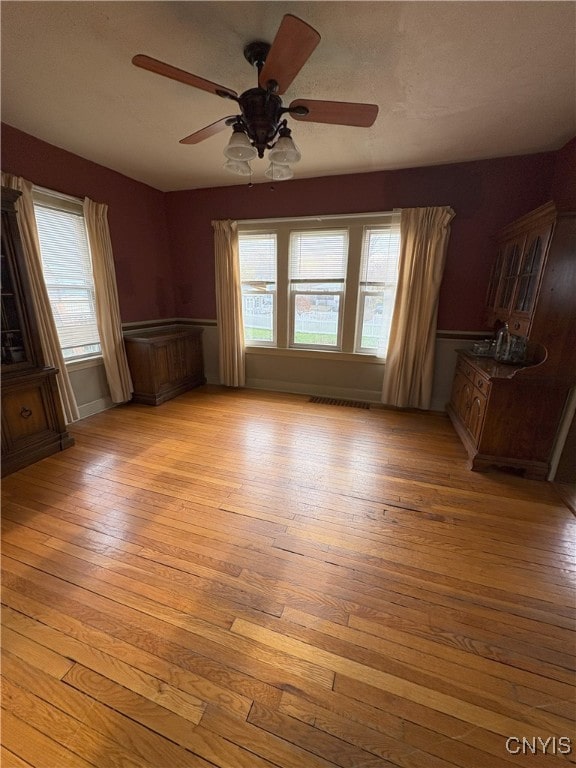 spare room featuring light hardwood / wood-style floors and ceiling fan