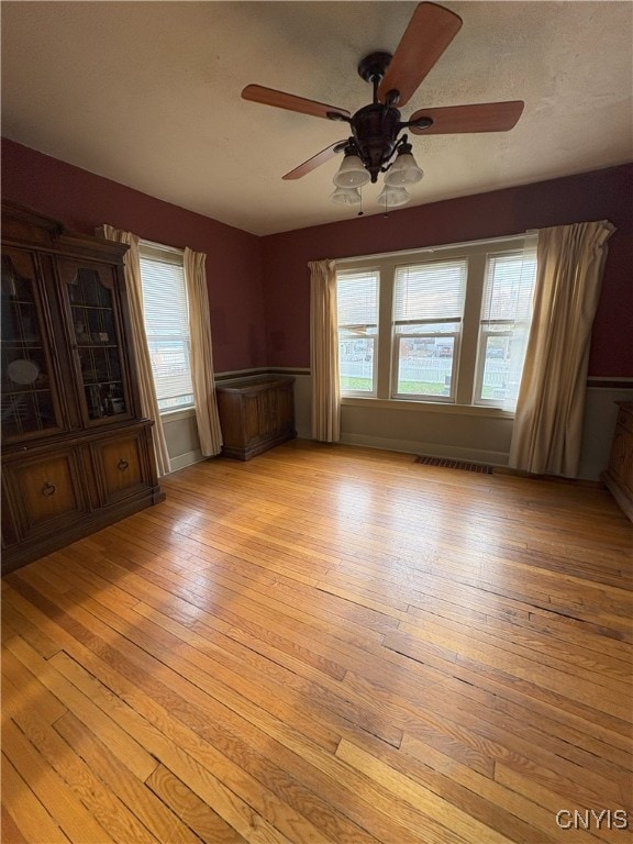 spare room with ceiling fan and light hardwood / wood-style floors