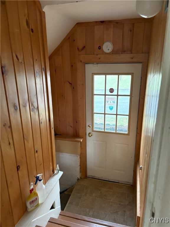 doorway featuring wooden walls