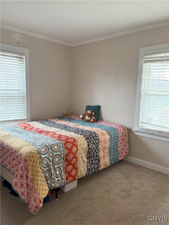 carpeted bedroom with ornamental molding