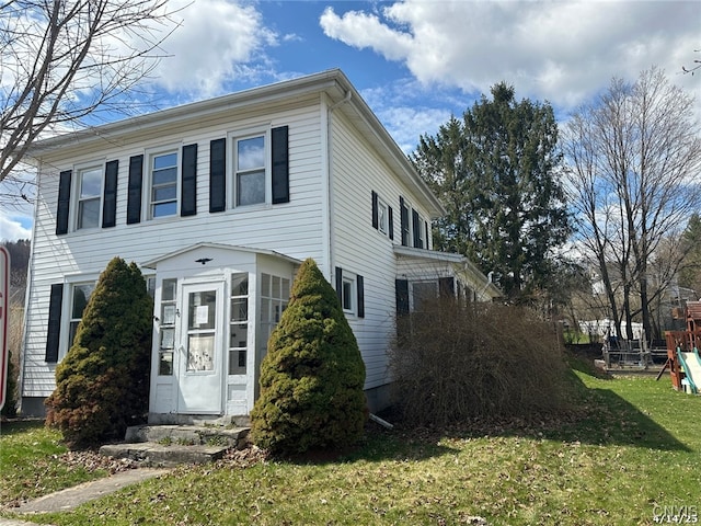 20 Pearl St, Bainbridge, NY 13733 - view of front facade with entry steps, a playground, and a front lawn
