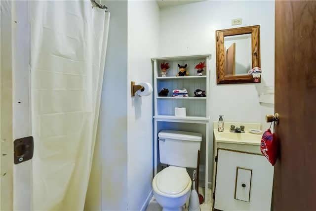 bathroom featuring a shower with curtain, toilet, and vanity