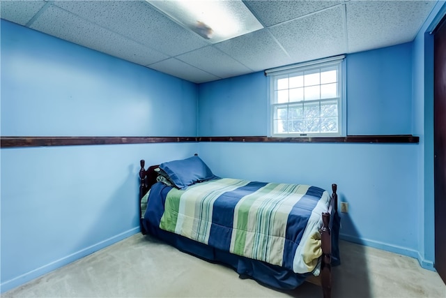 bedroom featuring carpet flooring and a paneled ceiling