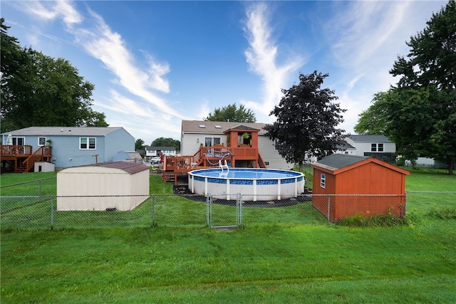 view of yard with a swimming pool side deck and a shed