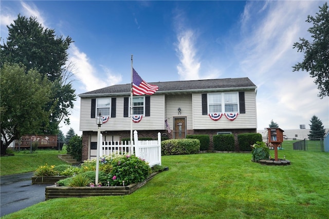 bi-level home with a front lawn