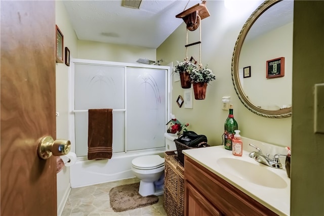 full bathroom with tile patterned floors, vanity, enclosed tub / shower combo, and toilet