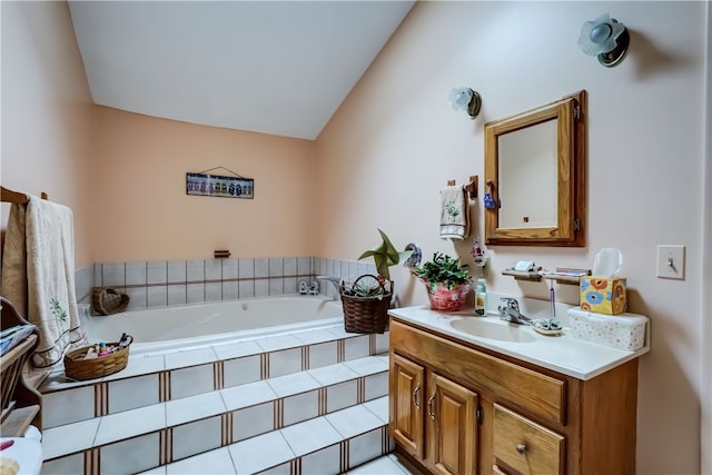 bathroom featuring vanity, a relaxing tiled tub, and lofted ceiling