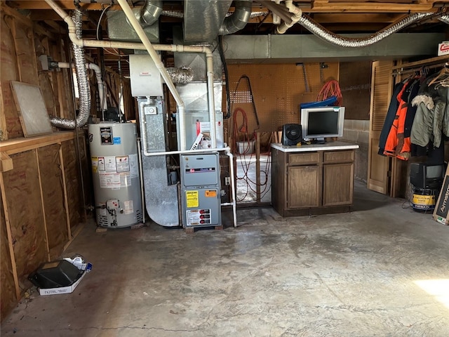 utility room with heating unit and water heater