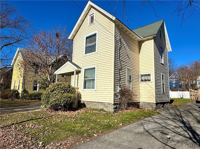 view of side of home featuring a lawn