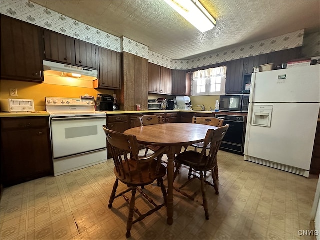 kitchen with black appliances, sink, dark brown cabinetry, and a textured ceiling