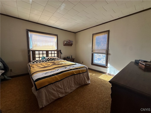 bedroom with dark colored carpet and ornamental molding