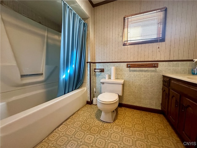 full bathroom with vanity, shower / bathtub combination with curtain, tile walls, and toilet