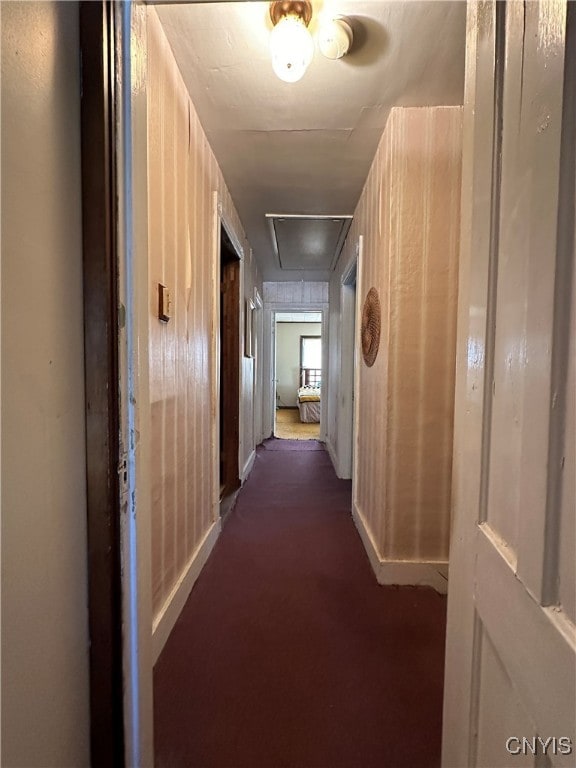 hallway featuring dark carpet