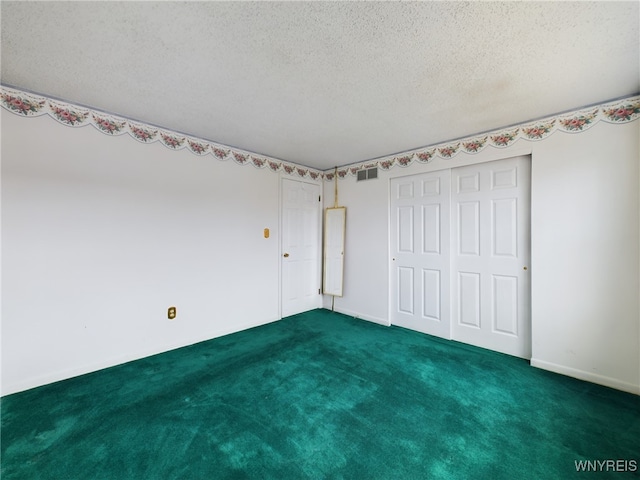 unfurnished bedroom with dark carpet, a textured ceiling, and a closet