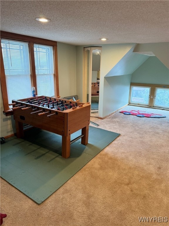 playroom with carpet flooring, a textured ceiling, and plenty of natural light