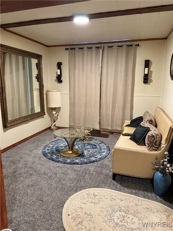 sitting room with carpet and beam ceiling