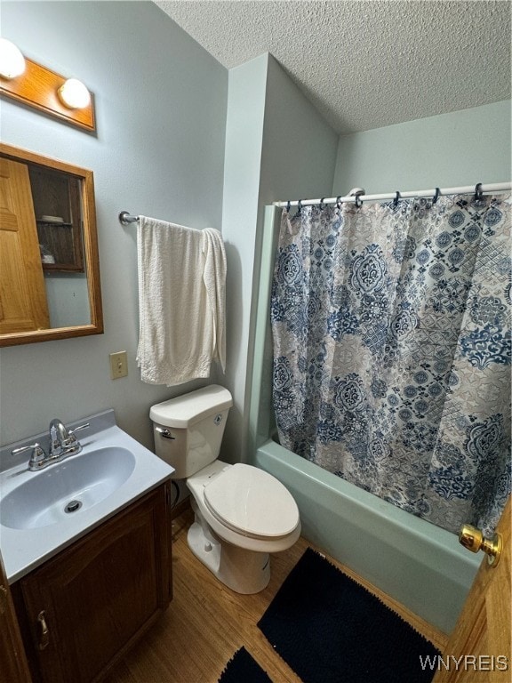 bathroom with vanity, toilet, wood-type flooring, and a textured ceiling