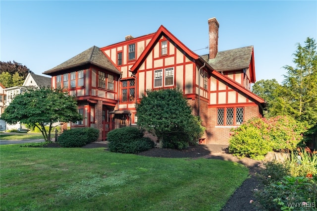 rear view of house featuring a yard