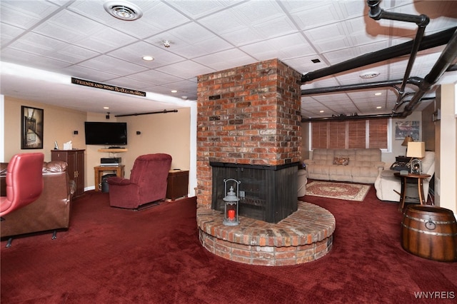 living room with a fireplace and carpet floors