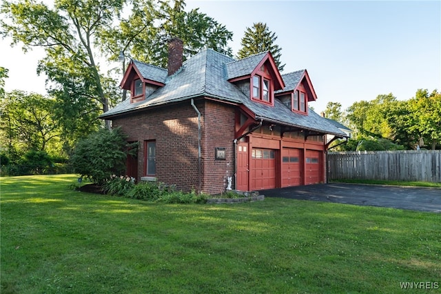 view of property exterior with a yard and a garage