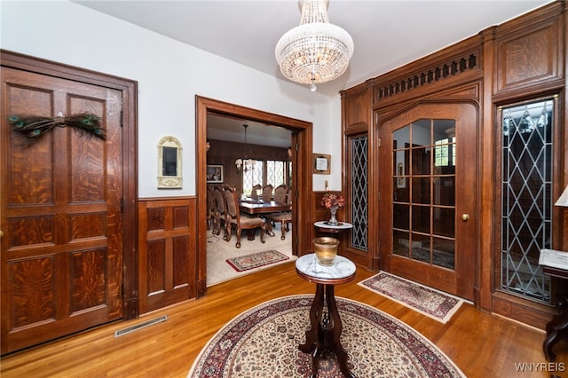 entryway with hardwood / wood-style flooring and an inviting chandelier