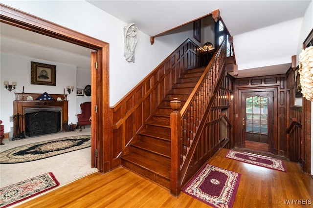 stairs featuring wood walls and wood-type flooring