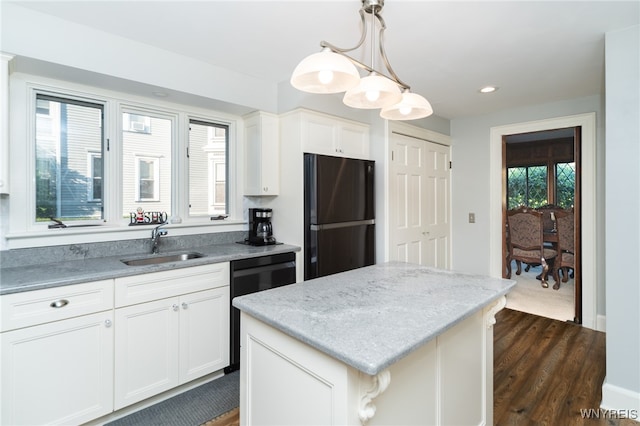 kitchen with a center island, white cabinets, hanging light fixtures, dark hardwood / wood-style floors, and stainless steel refrigerator