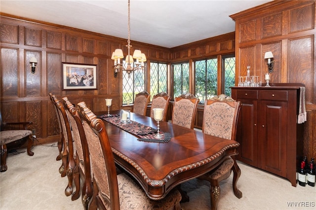 carpeted dining space featuring wooden walls, ornamental molding, and a notable chandelier