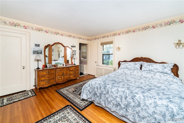 bedroom featuring hardwood / wood-style floors and ornamental molding