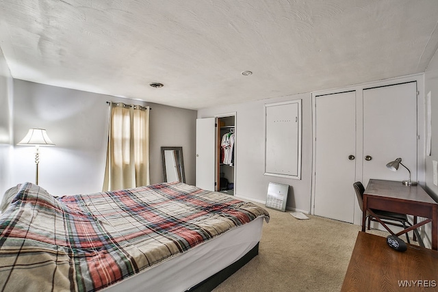 bedroom featuring a textured ceiling and carpet floors