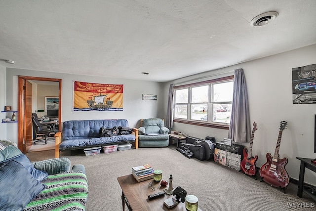 living room featuring carpet floors and a textured ceiling