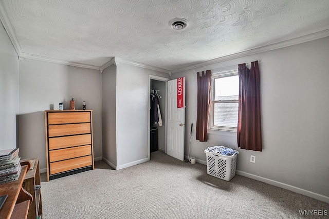 carpeted bedroom featuring ornamental molding, a textured ceiling, and a closet