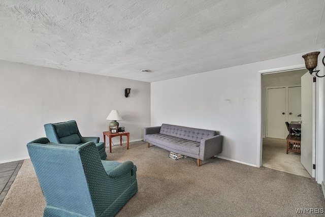 carpeted living room featuring a textured ceiling