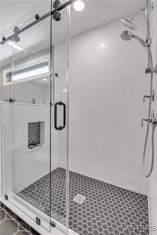 bathroom with tile patterned floors and a shower with door