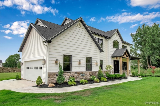 view of front of house with a garage and a front lawn